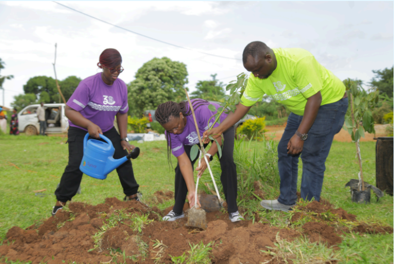 Elizabeth, Patricia and Emmanuel planting a tree